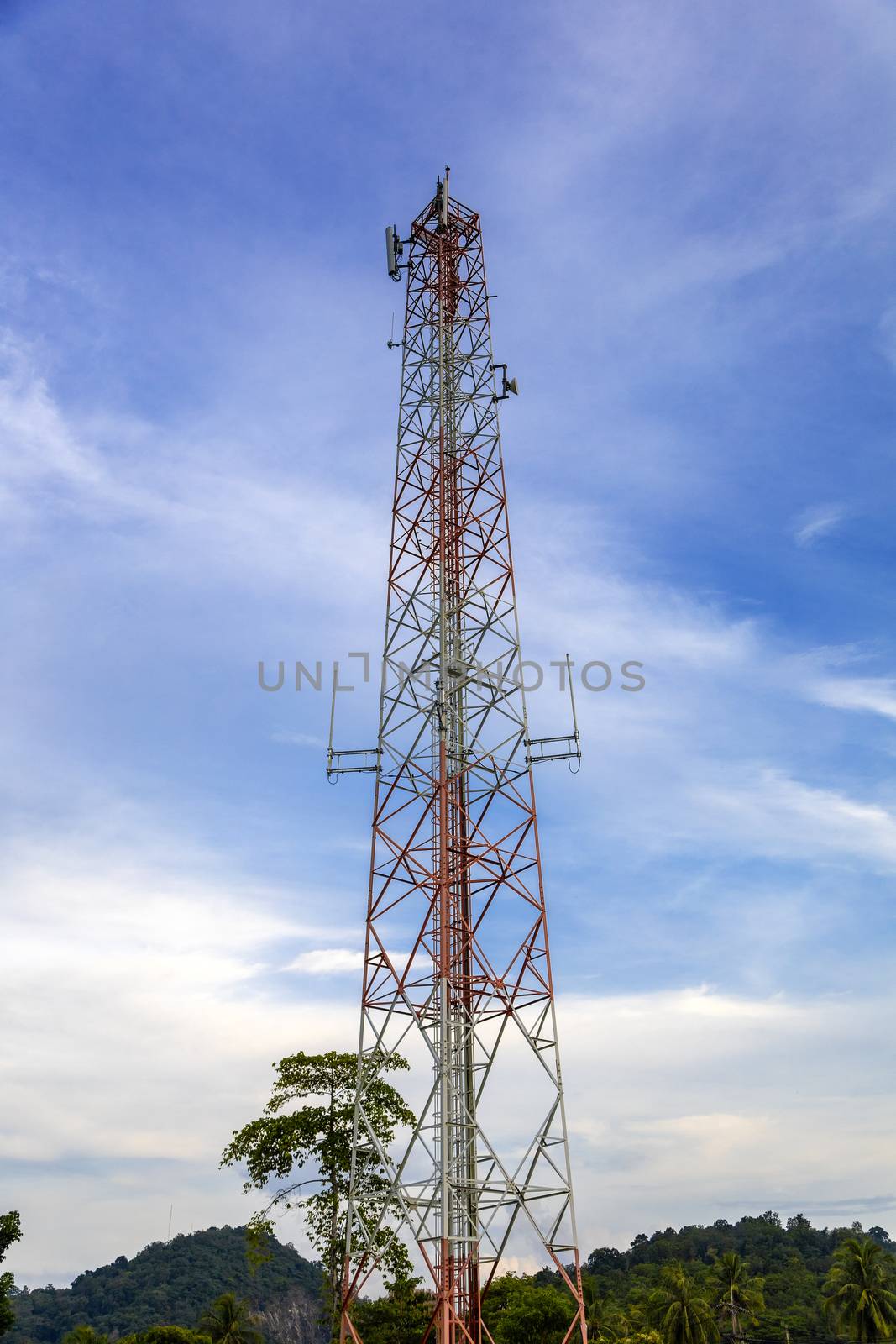 mobile phone communication and network signal repeater antenna tower with blue sky background