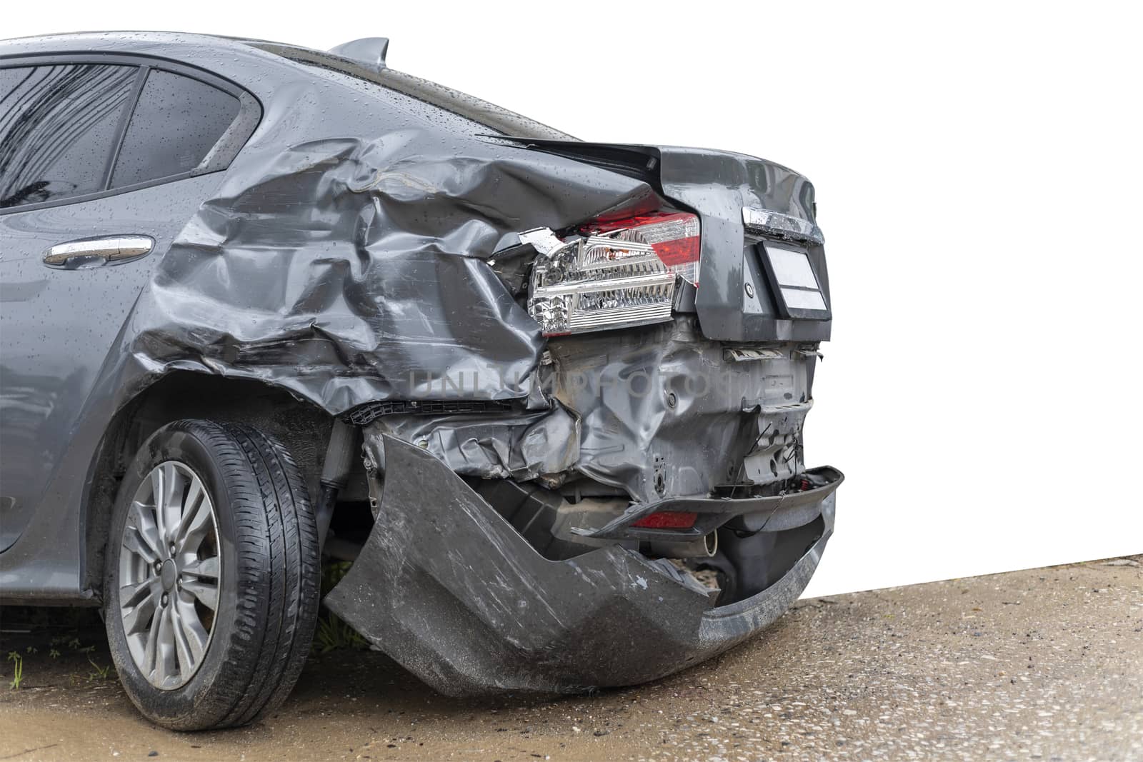 In raining day back side of  gray color car damaged and broken by accident on road parking can not dirve any more. isolate on white background. Save with cliping path