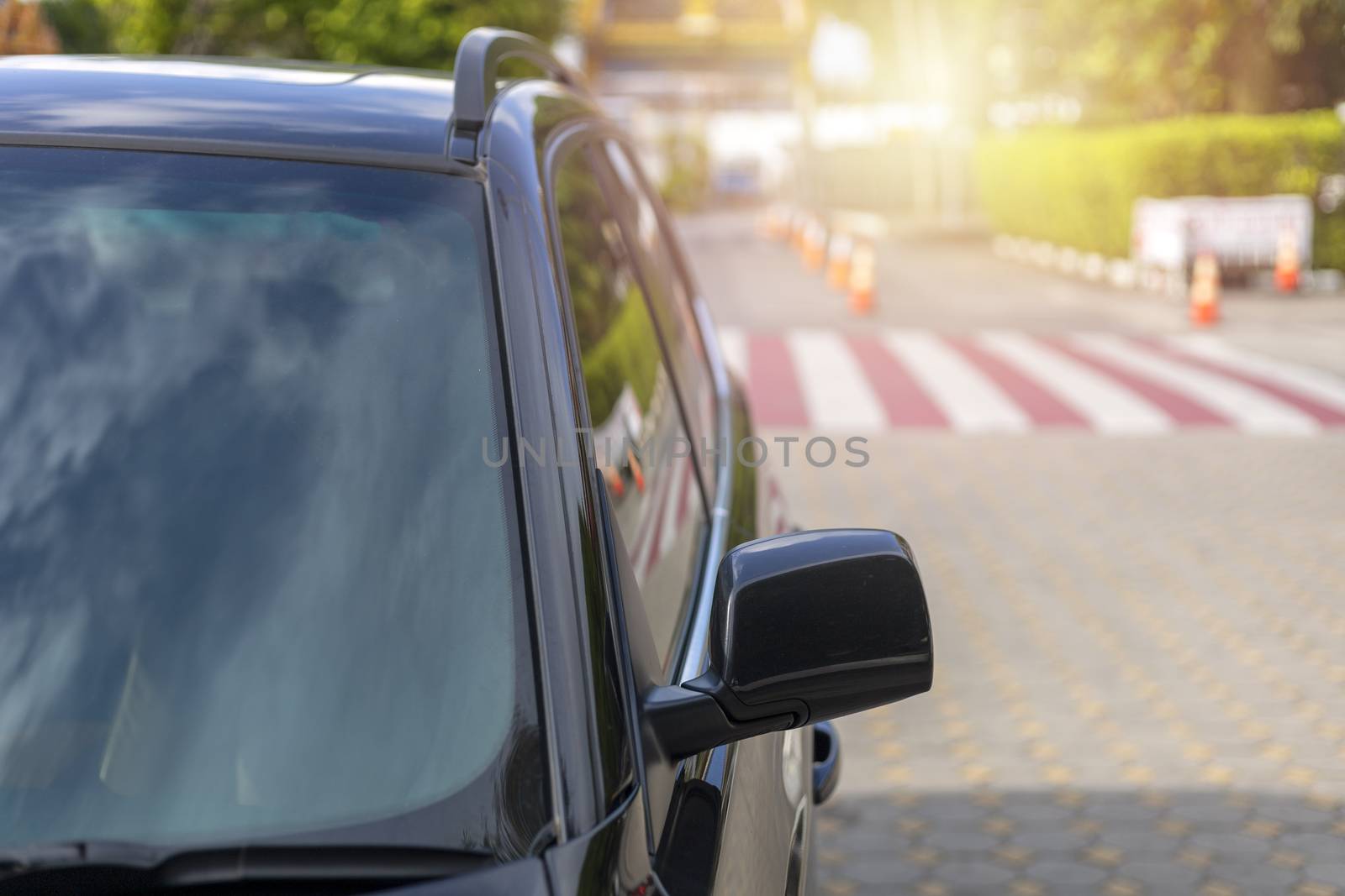 Front of Black color car with Windshield and back side wing mirror park on road