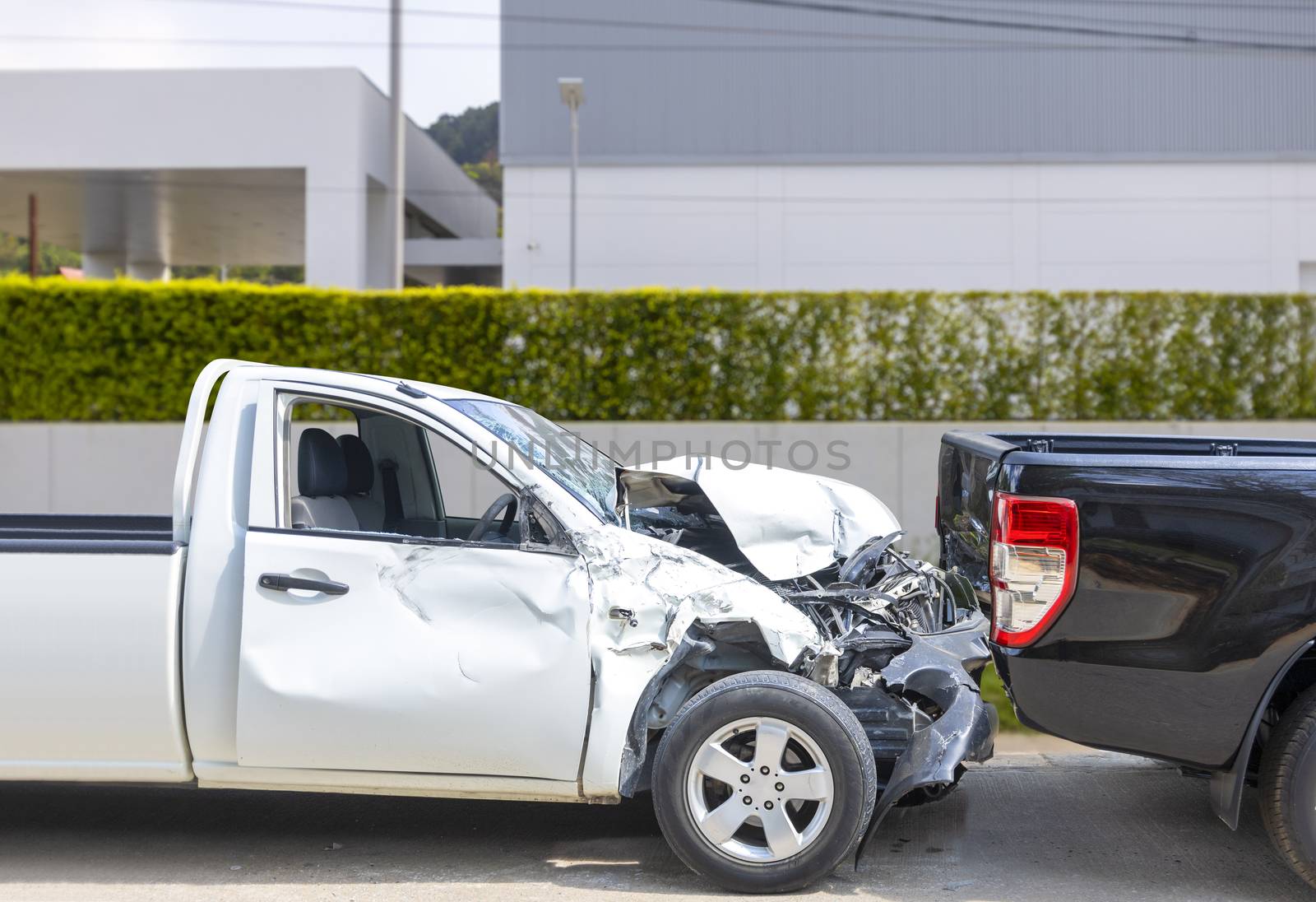 Front White color pack up car crash with back side black color car get damaged by accident on city street.