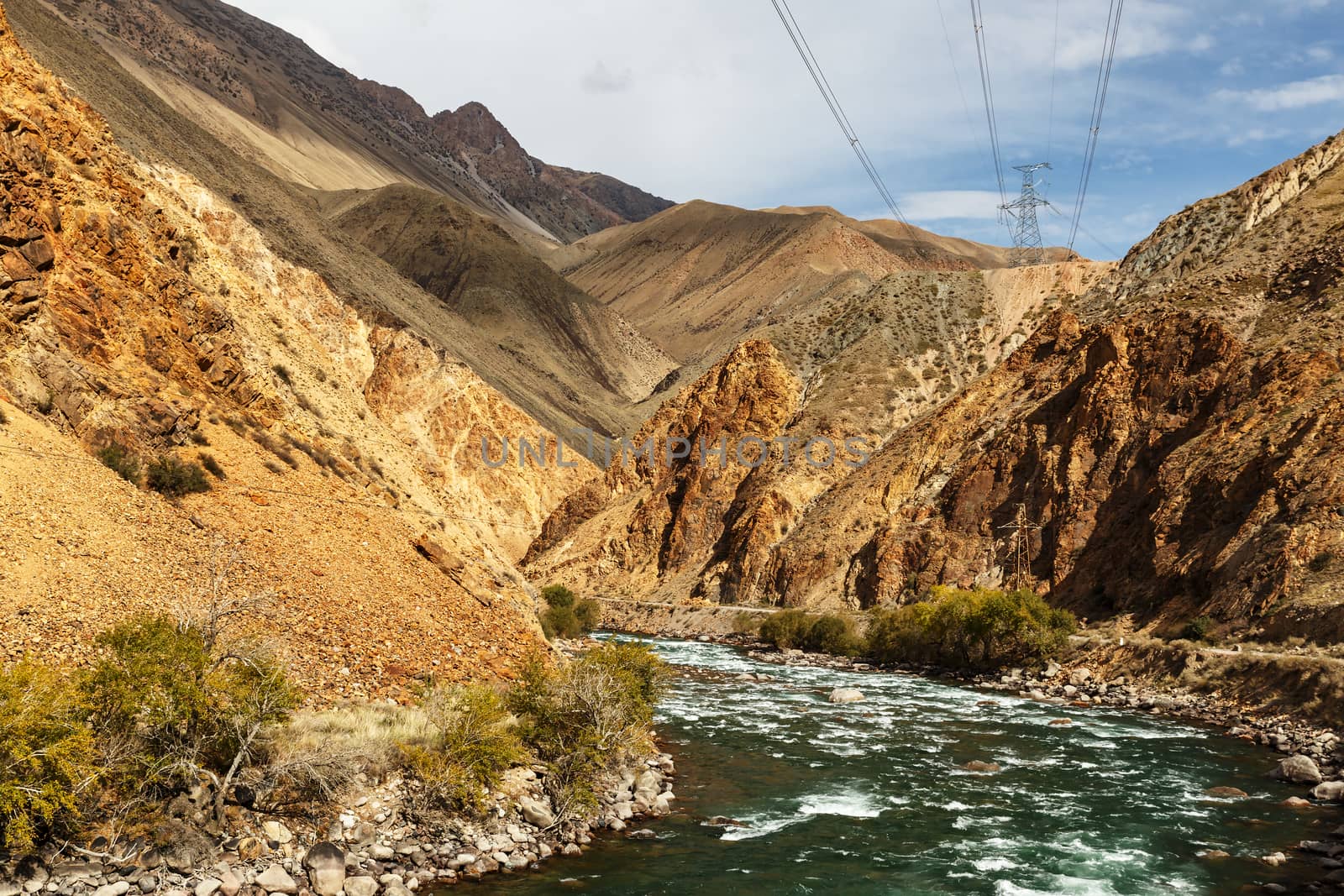 mountain river and power lines. Kokemeren river in Naryn Region of Kyrgyzstan.