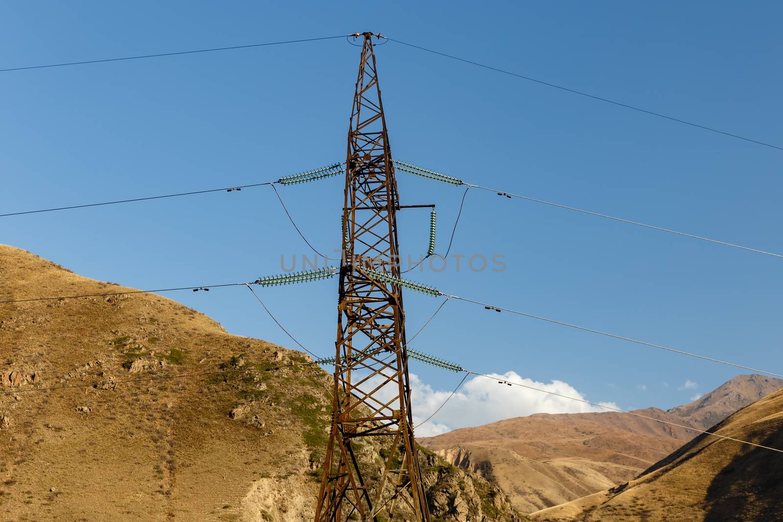 High voltage power lines in the mountains of Kyrgyzstan, electricity pylon