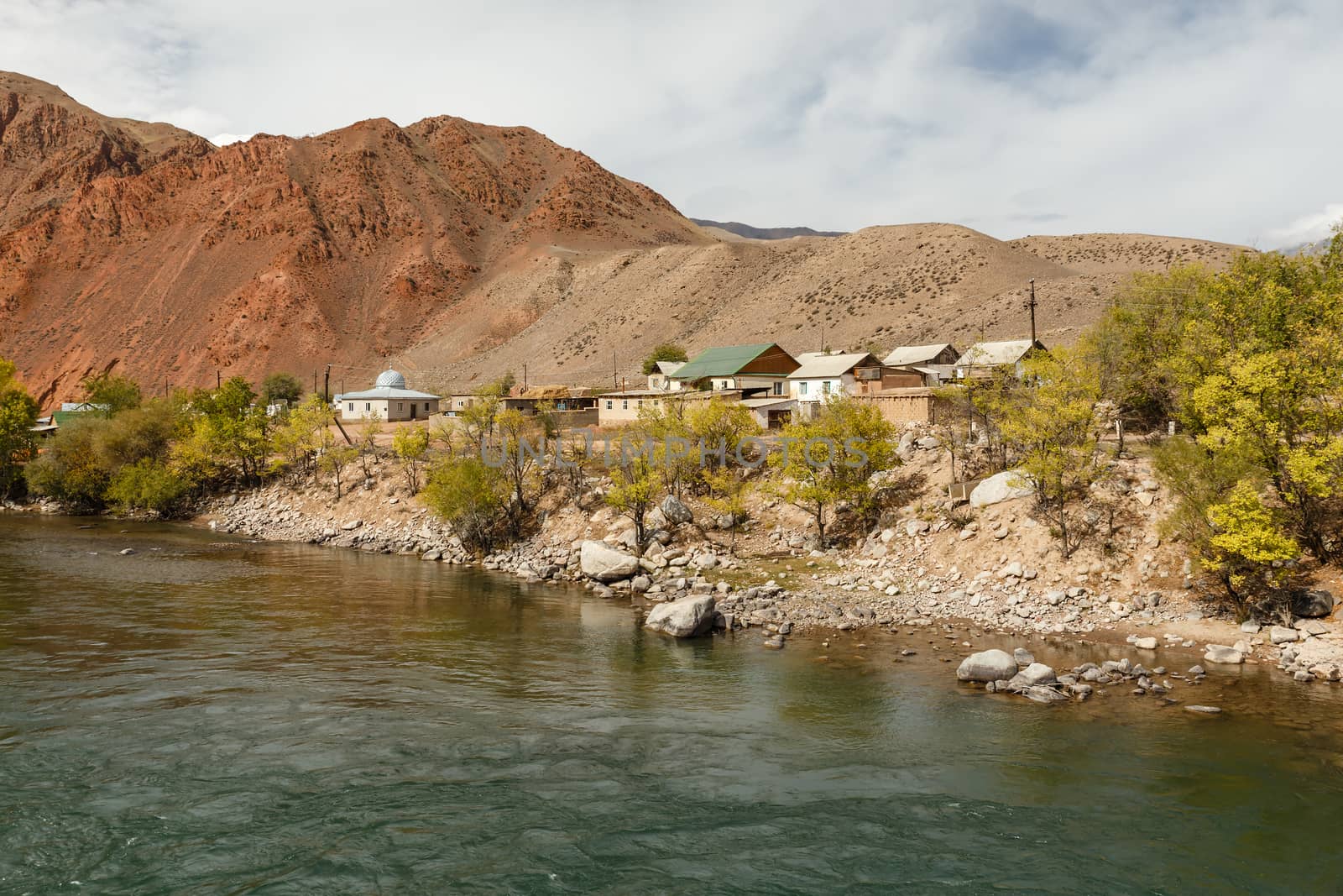 Kokemeren river, houses by the river in the village of Aral, Jumgal district of Naryn region in Kyrgyzstan