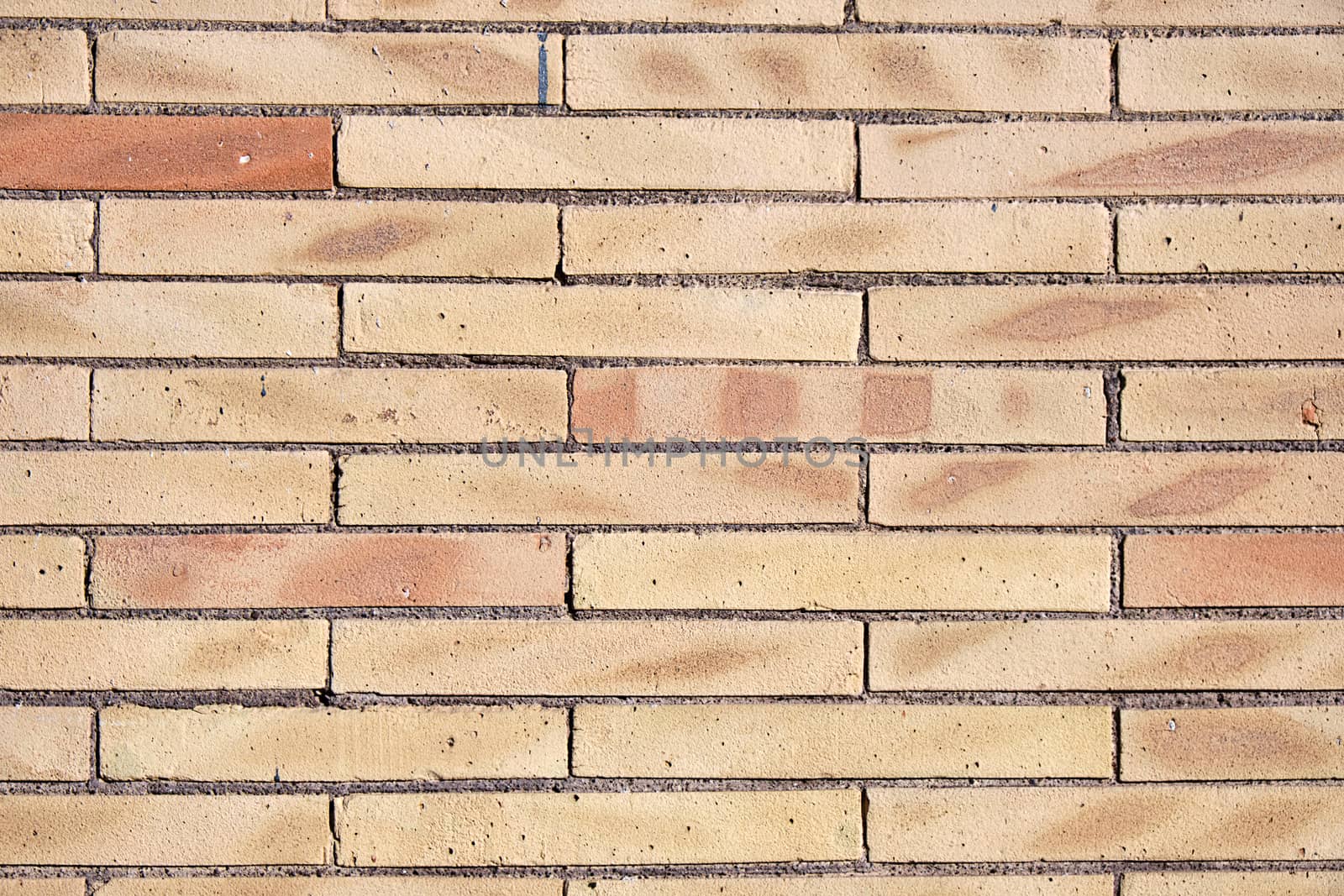 Background from a wall of beige clinker bricks