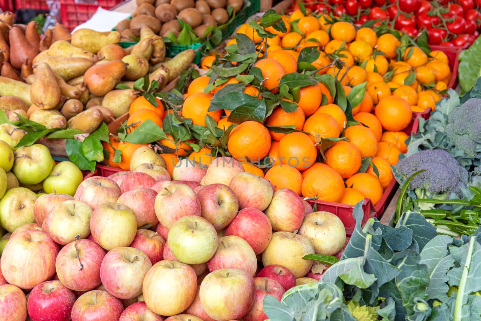 Apples, tangerines and other fruits and vegetables for sale at a market