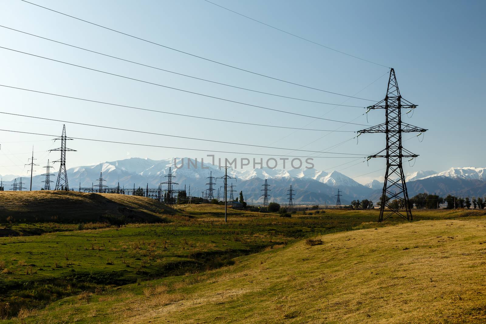 high-voltage power line in the mountains, electric high voltage power post, Kyrgyzstan