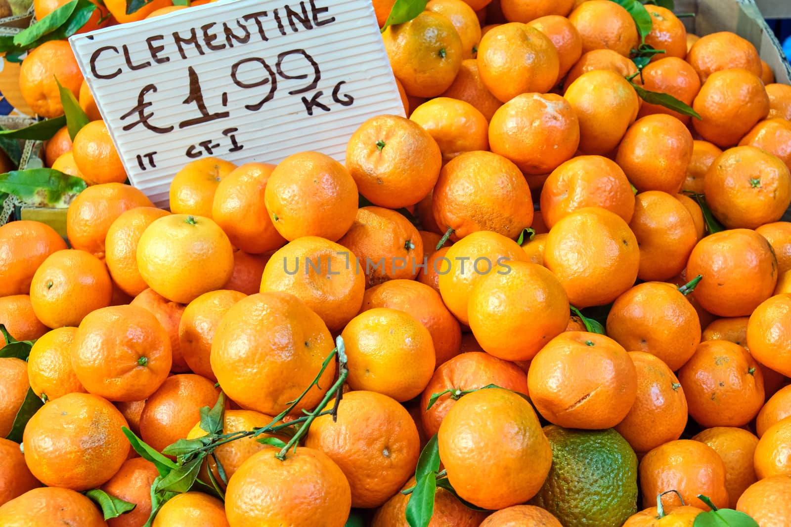 A pile of clementines for sale at a market