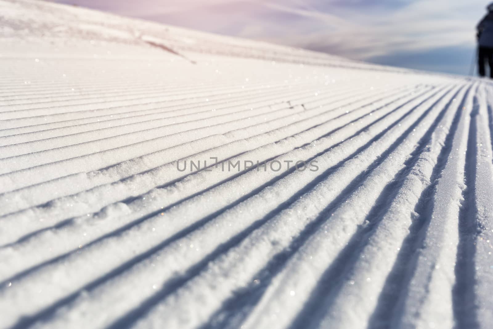 Close-up groomed snow at ski resort, slope banner background texture