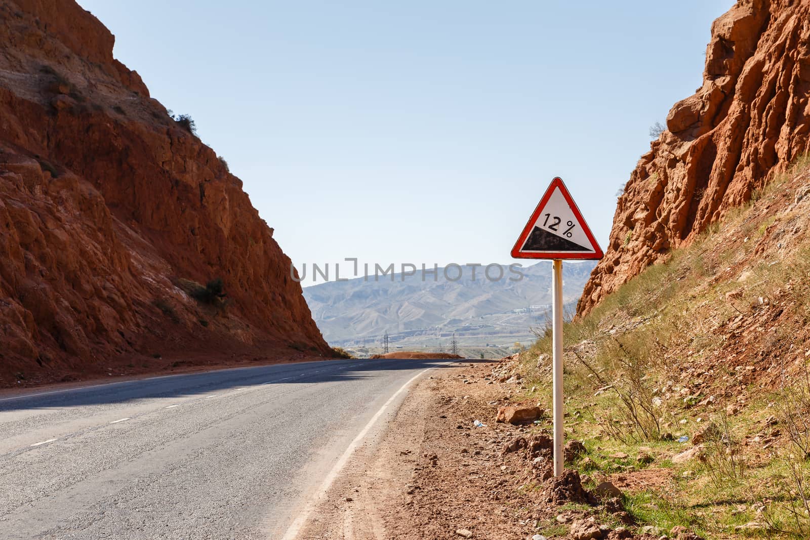 Downhill road sign with percentage on a mountain road, warning traffic sign kyrgyzstan