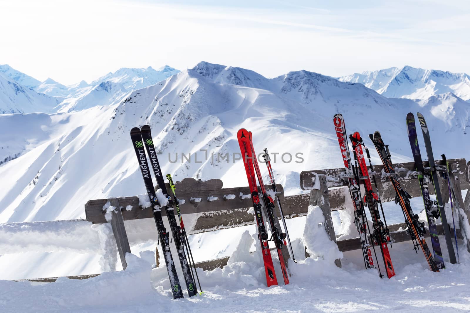 Saalbach, Austria - January 19, 2019: A rack packed with skis and beautiful alps in the background, Europe