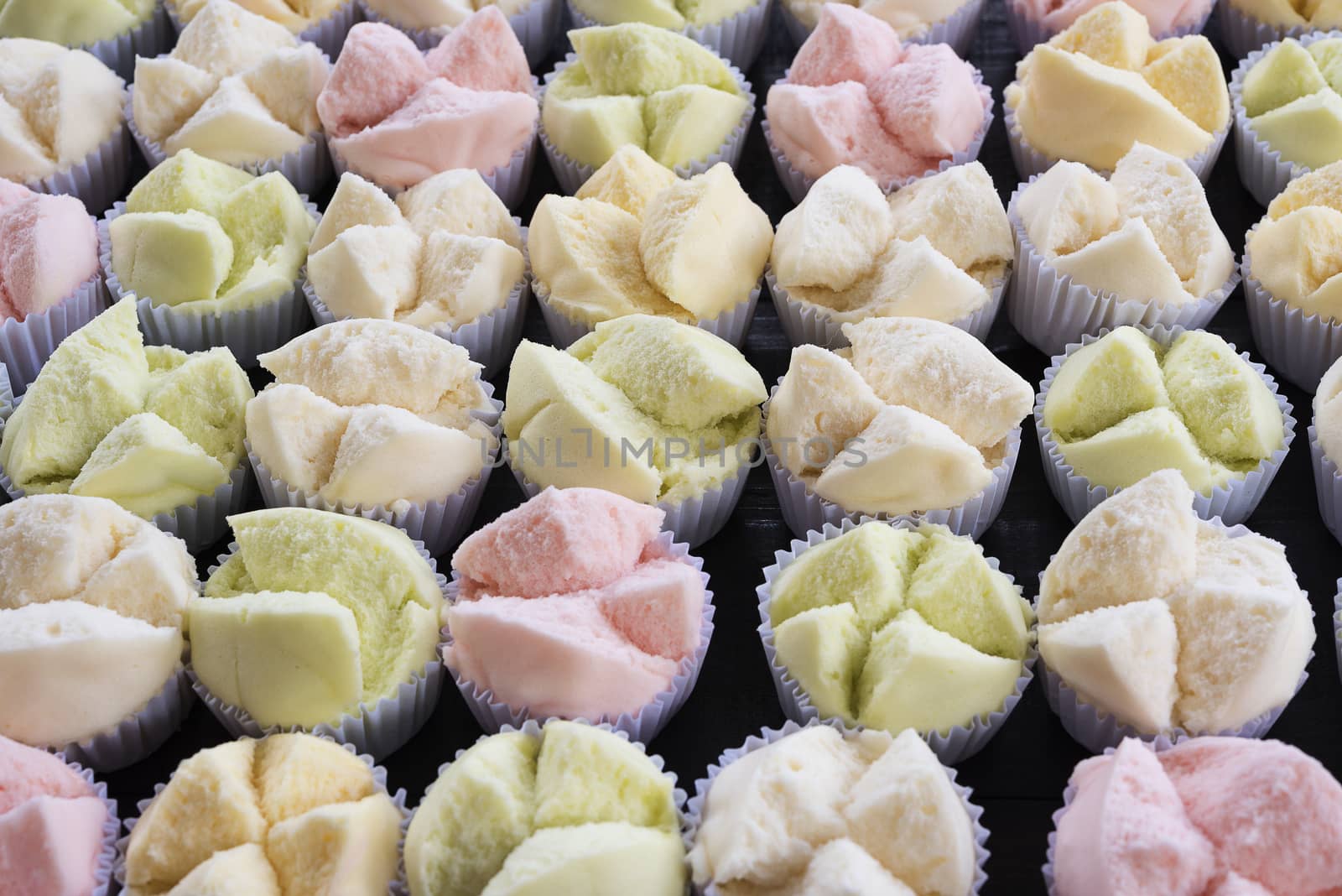 colorfull Thai dessert Thai steamed cupcakes or cakes cotton wool in paper cup on wood table