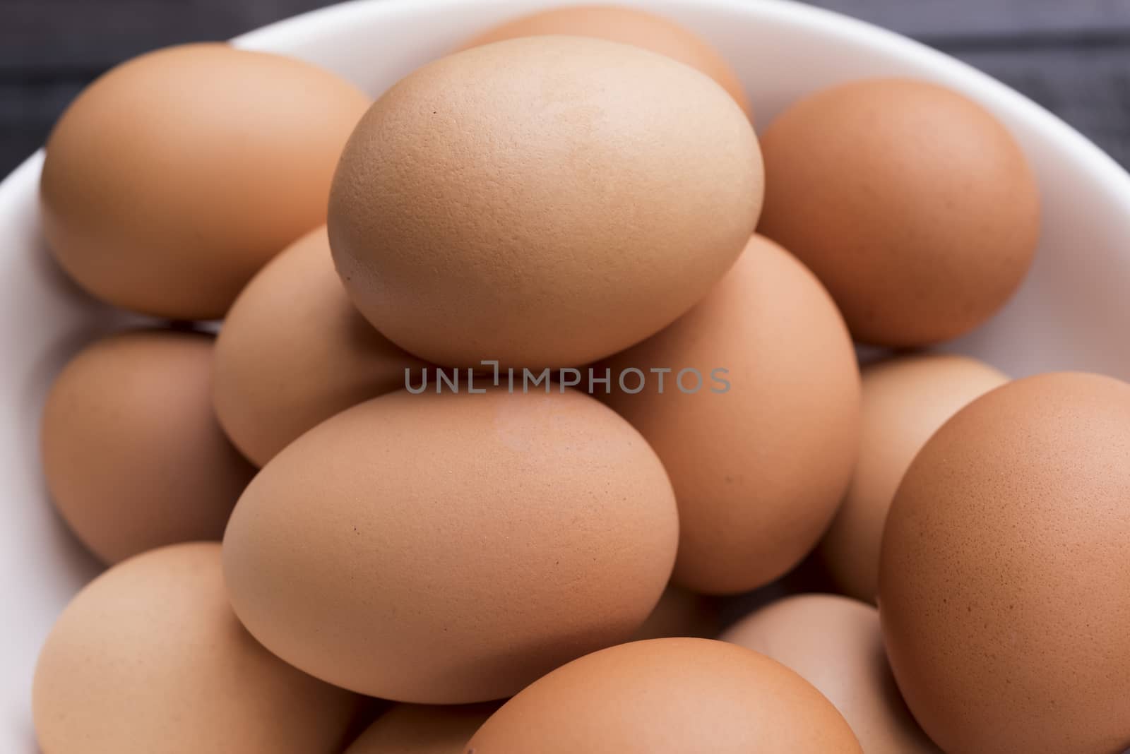 Close up fresh hen gee in white bowl on wood table
