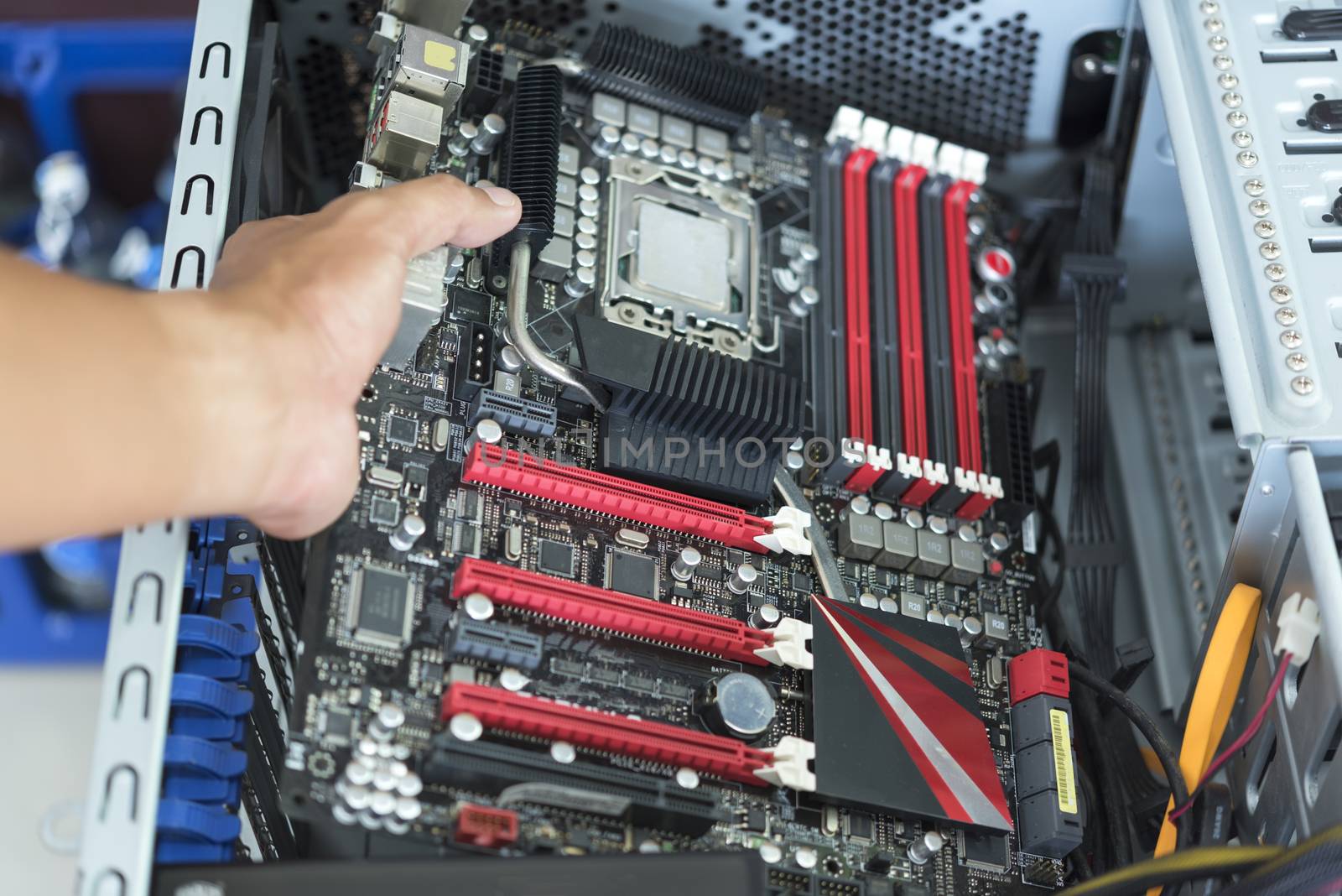 Hand put mainboard with CPU into ATX computer case with cable