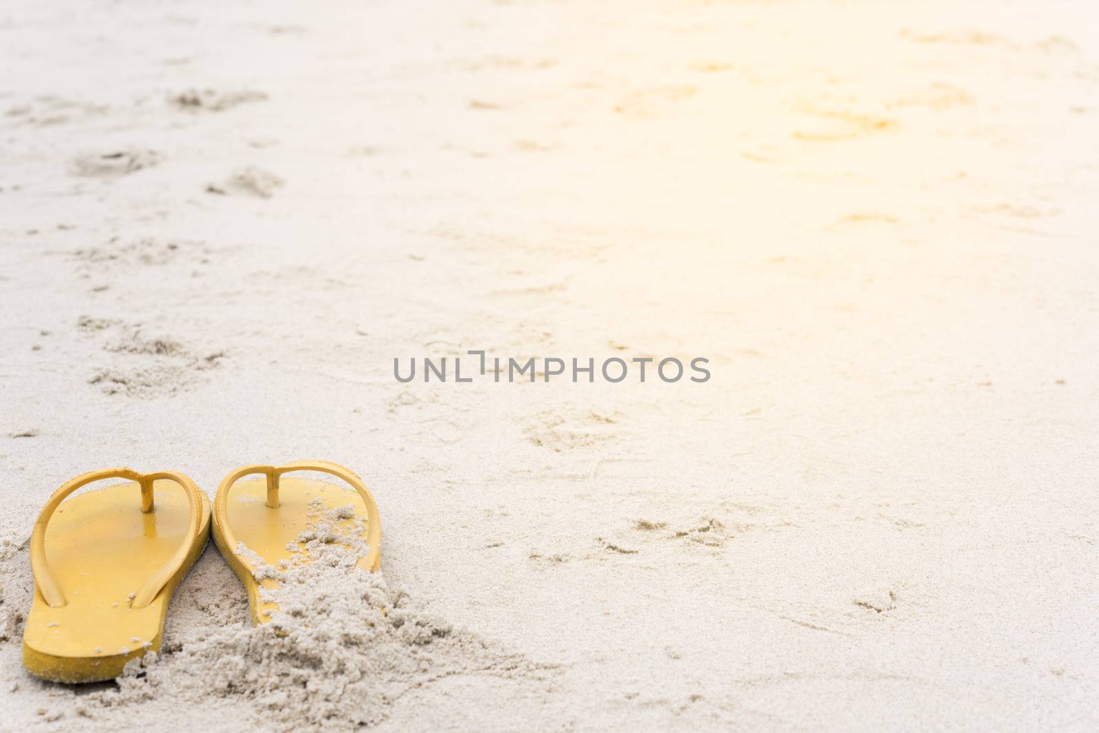 Summer holiday on the beach yellow sandals on the beach have sunset