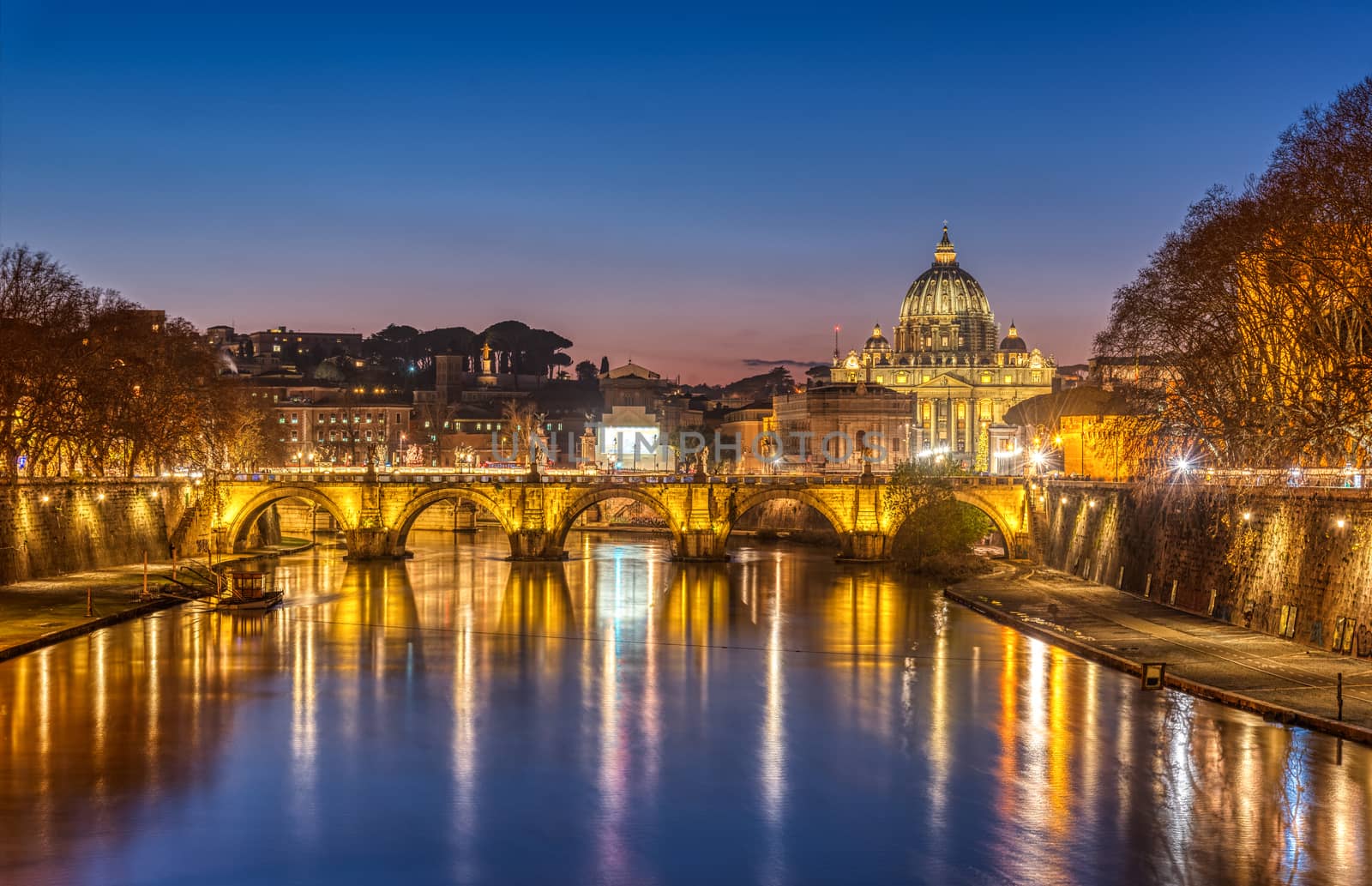 The Tiber river and St. Peters Basilica in the Vatican City, Italy, at twilight