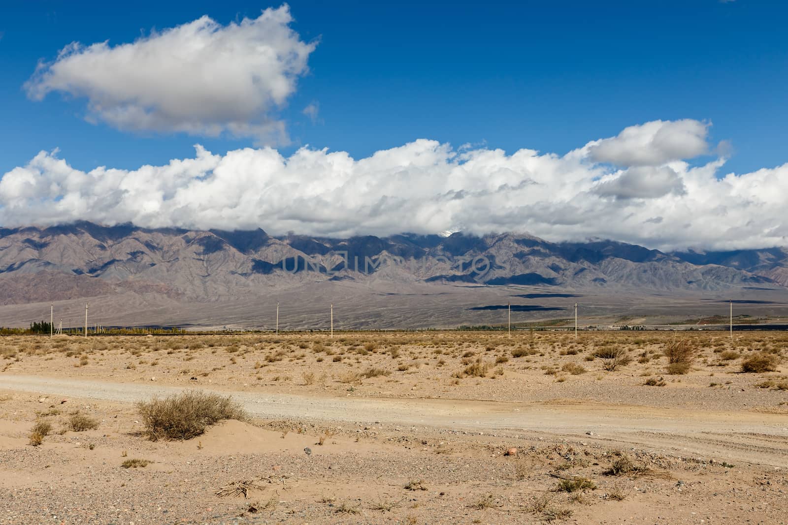 white clouds on the tops of mountains in the region of Issyk-Kul Lake by Mieszko9