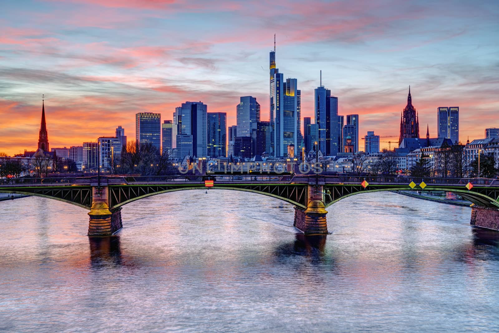 The financial district in Frankfurt in Germany and the Main river after sunset