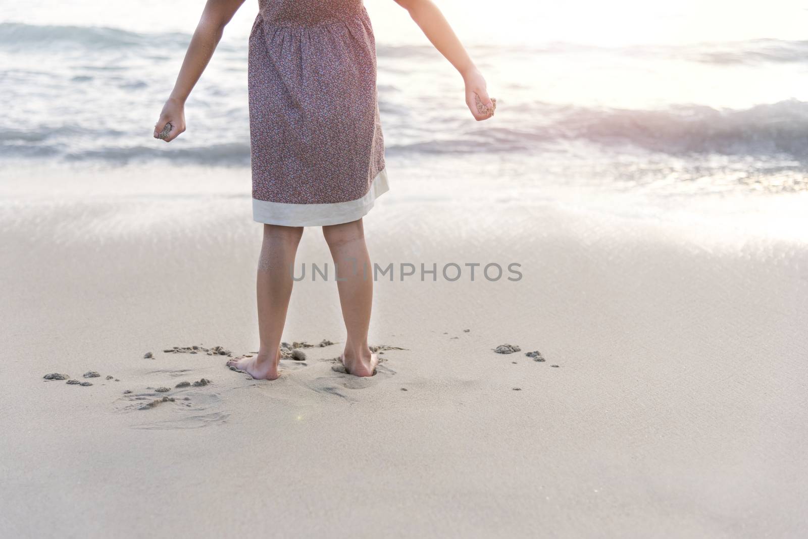 Children stand on the beach