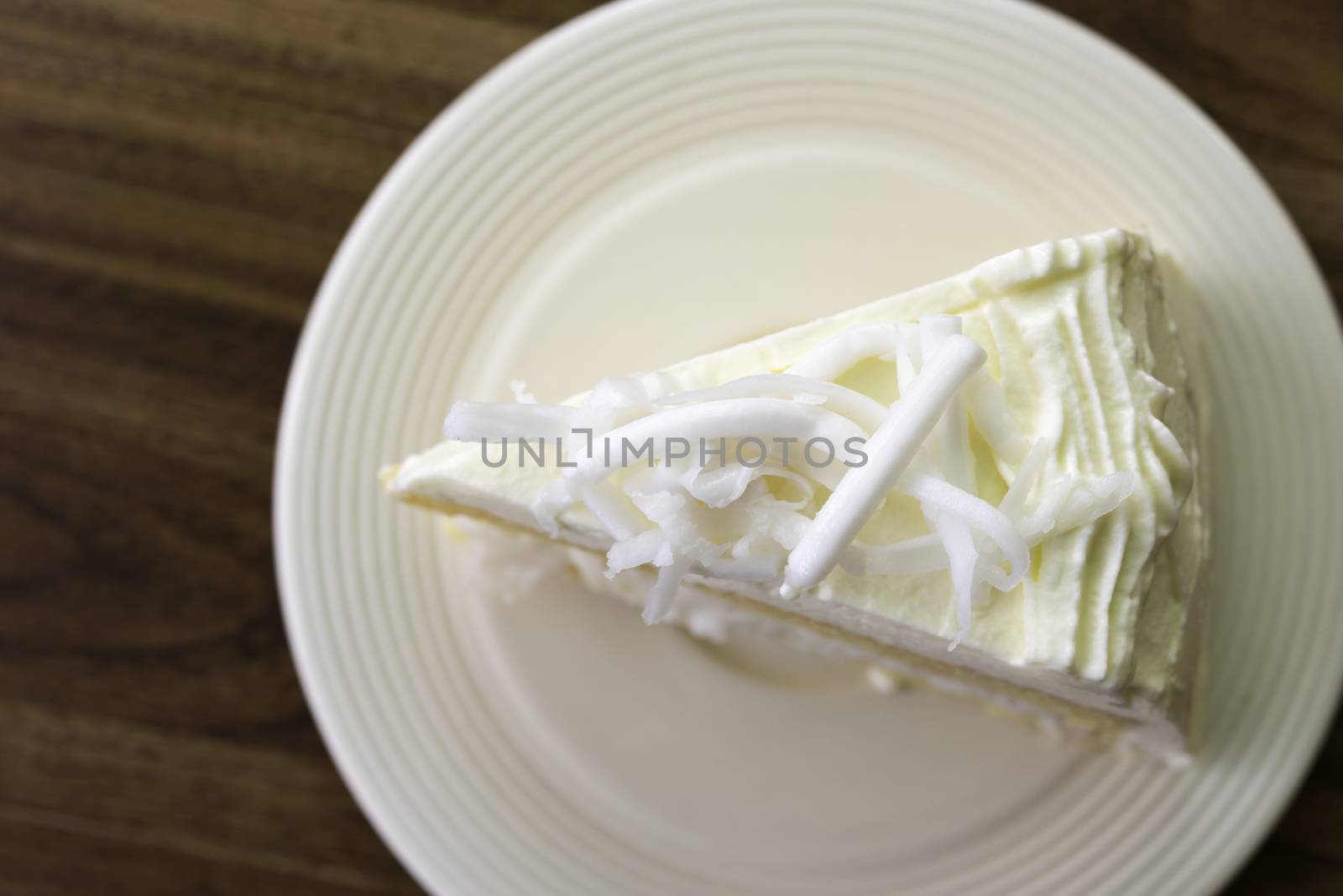 A piece of coconut cake on white dish