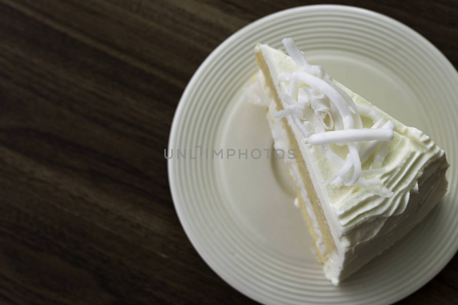 A piece of coconut cake on white dish