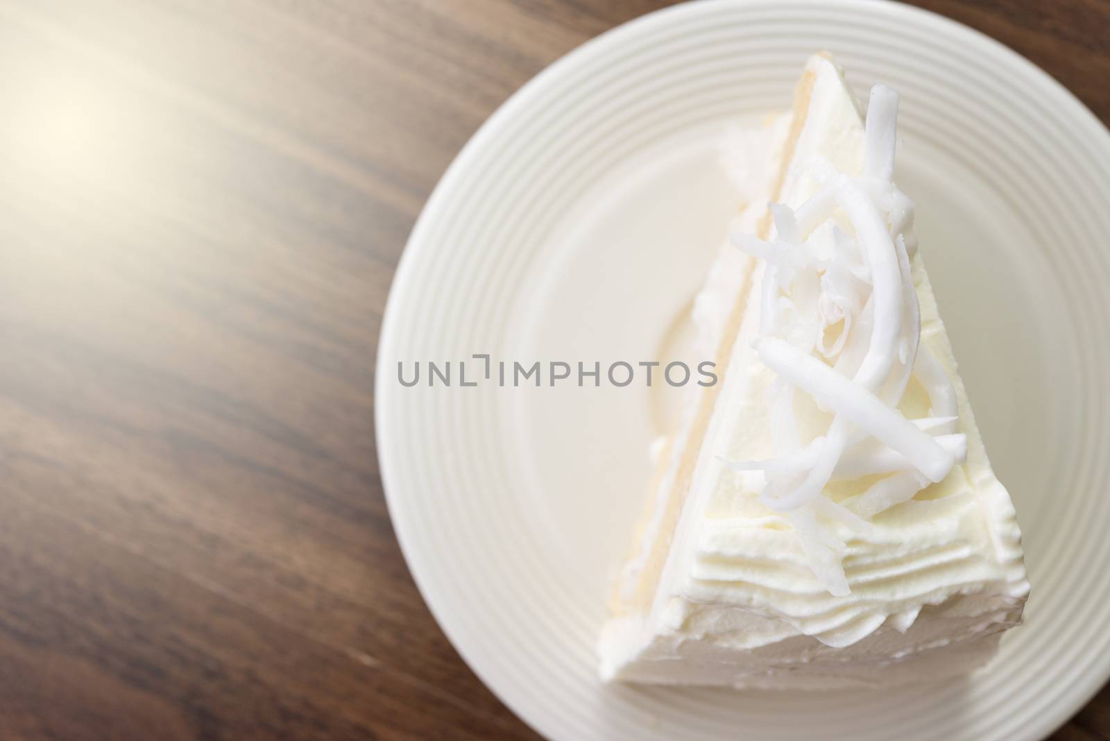 A piece of coconut cake on white dish