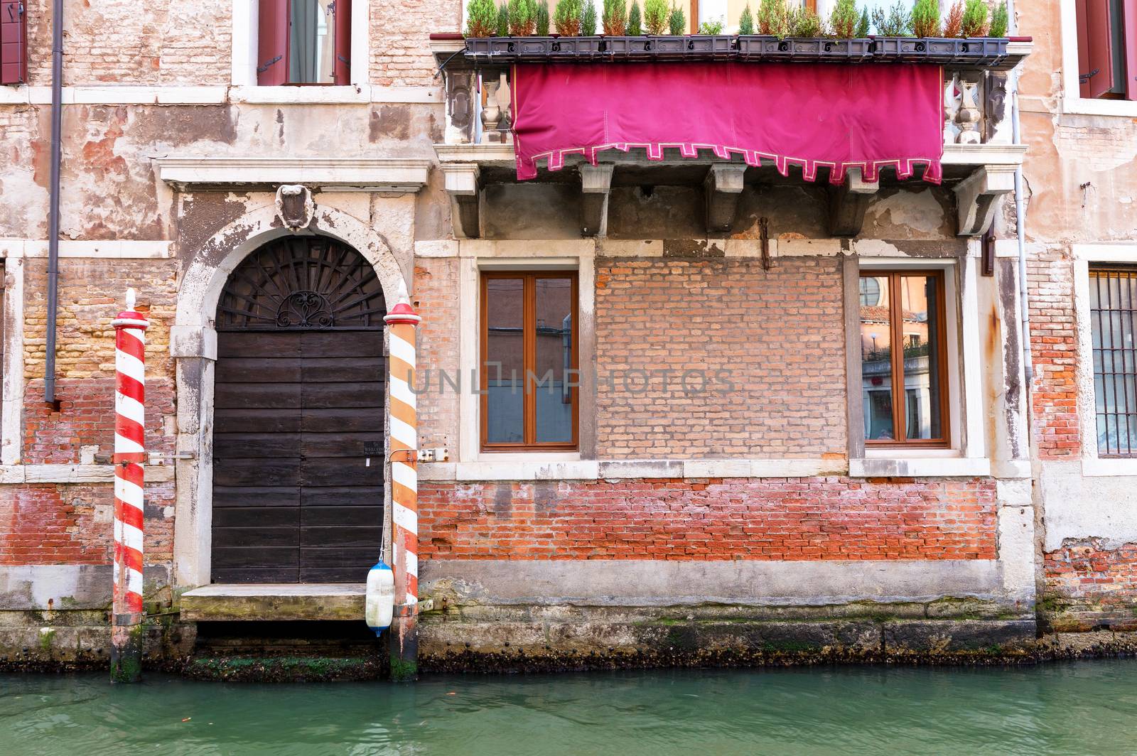 Small canal in venice with old buildings balconies a fading pain by necro79