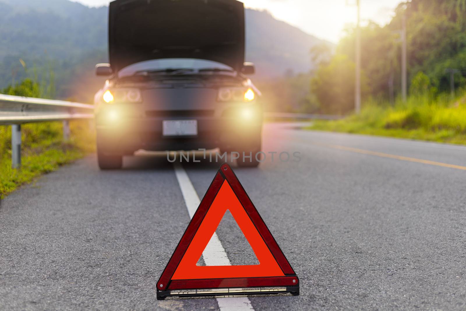 Red triangle, red emergency stop sign, red emergency symbol and black car stop and park on road.