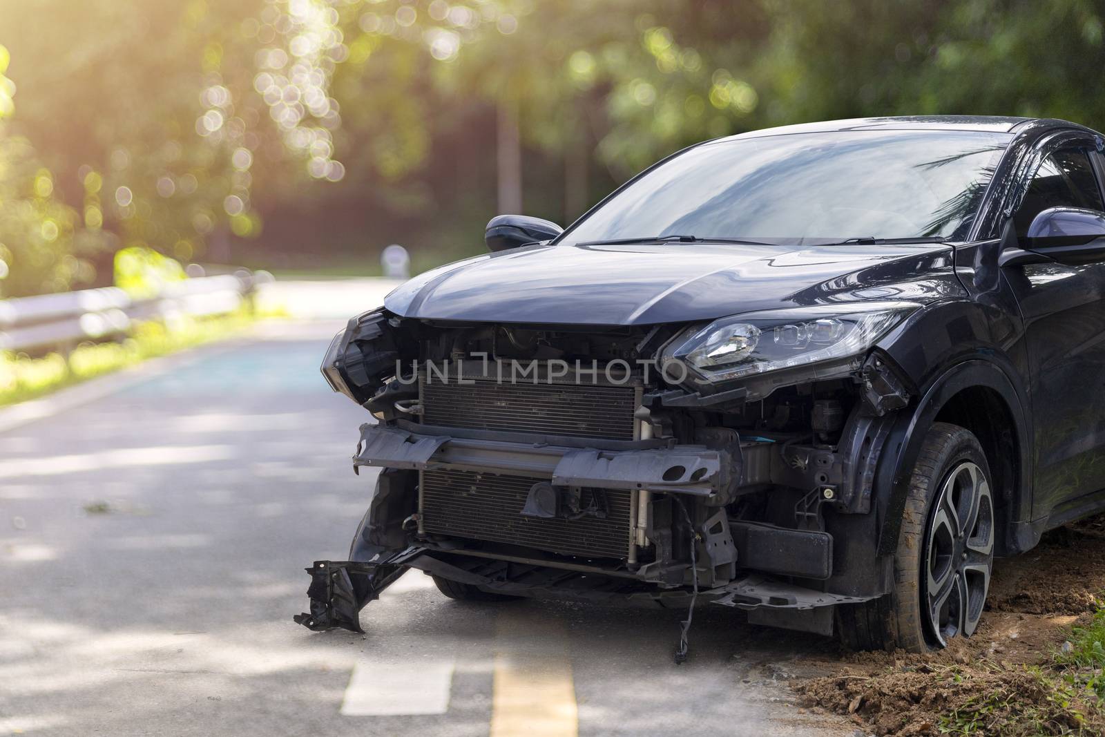 Front of black color car big damaged and broken by accident on city street parking can not drive any more. With copy space for text or design