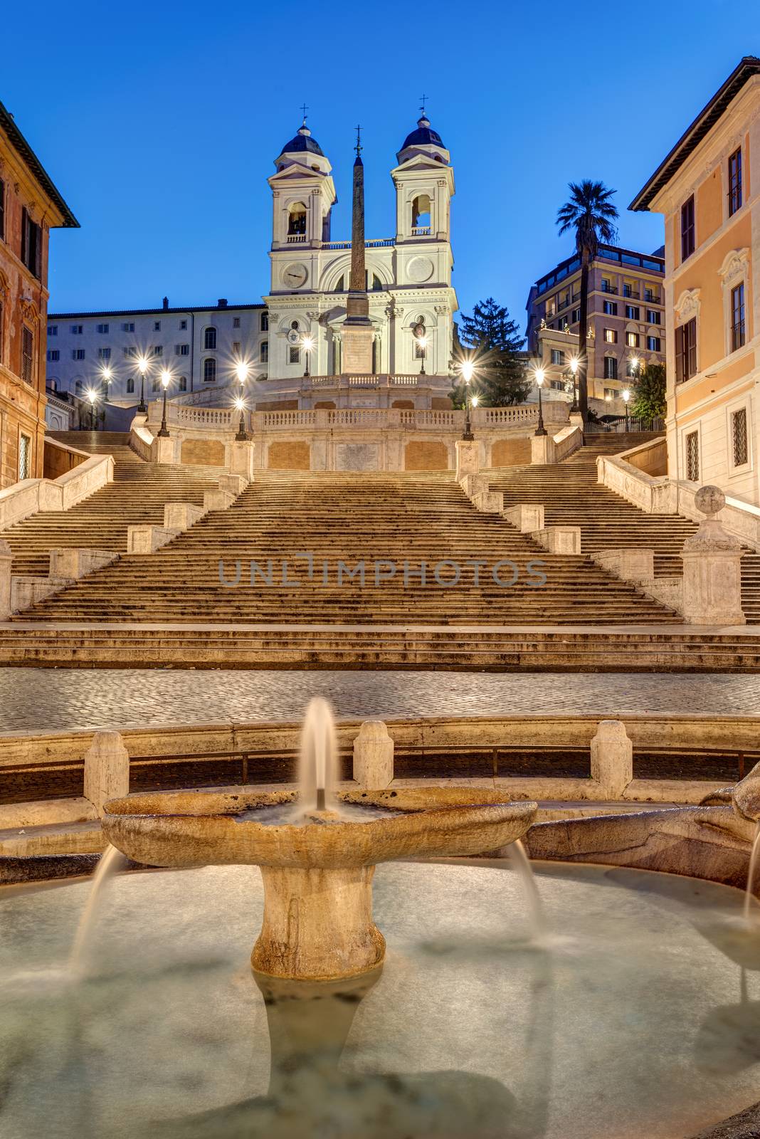The famous Spanish Steps with a fountain in Rome at dawn