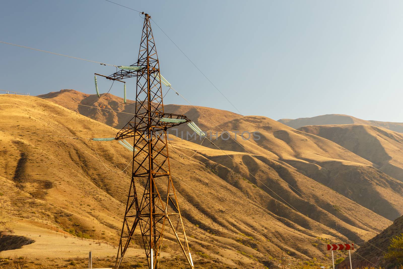 high voltage power transmission pylon in the mountains, high voltage post Mountain landscape