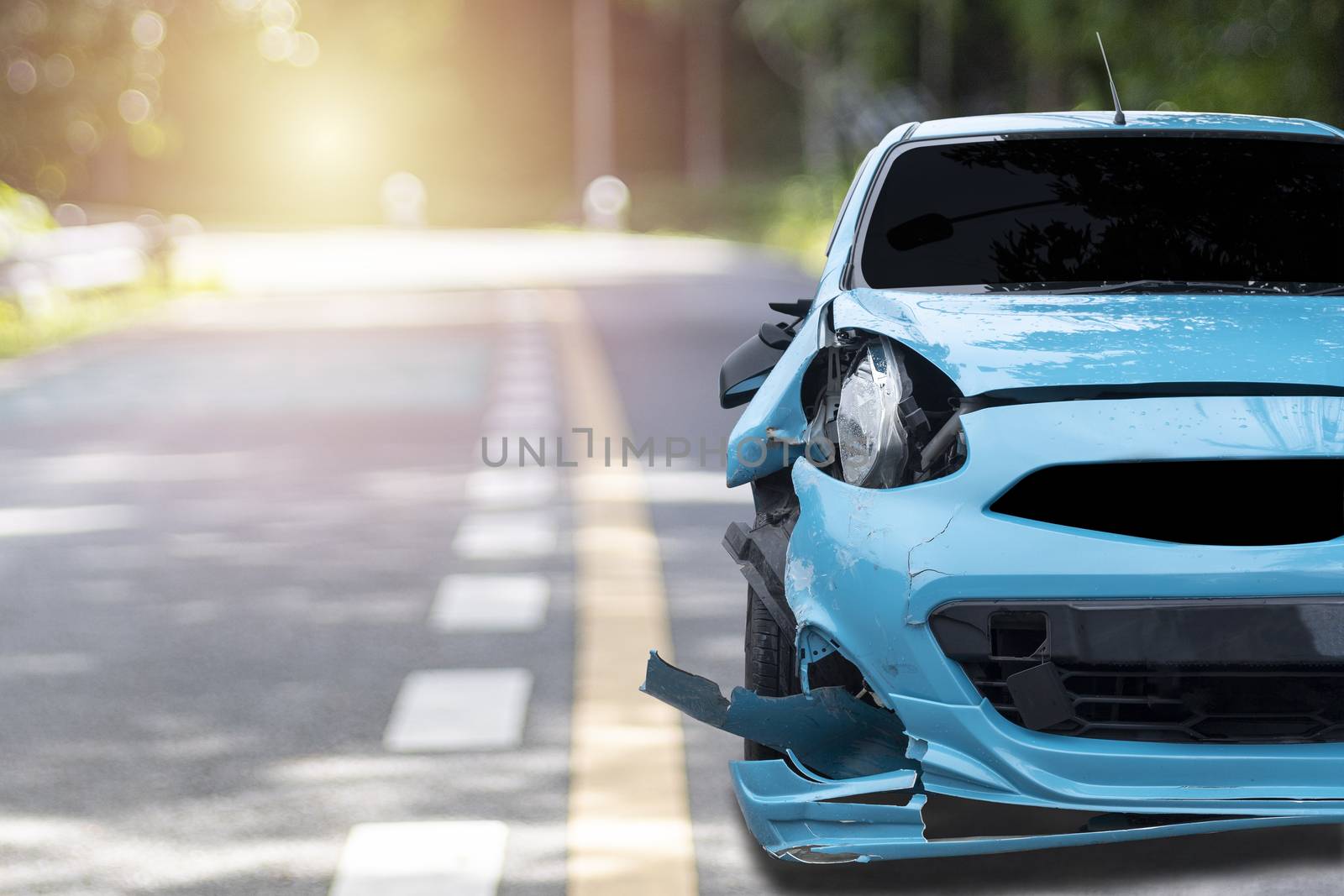 Front of blue color car big damaged and broken by accident on city street parking can not drive any more. With copy space for text or design