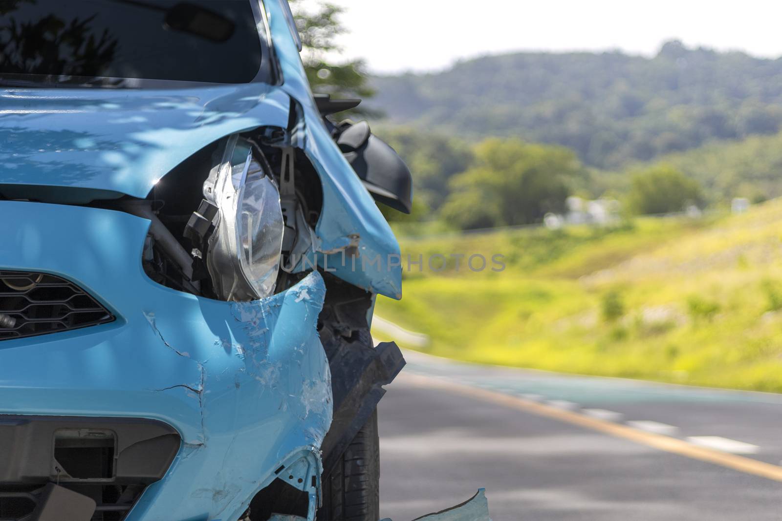 Front of blue color car big damaged and broken by accident on city street parking can not drive any more. With copy space for text or design