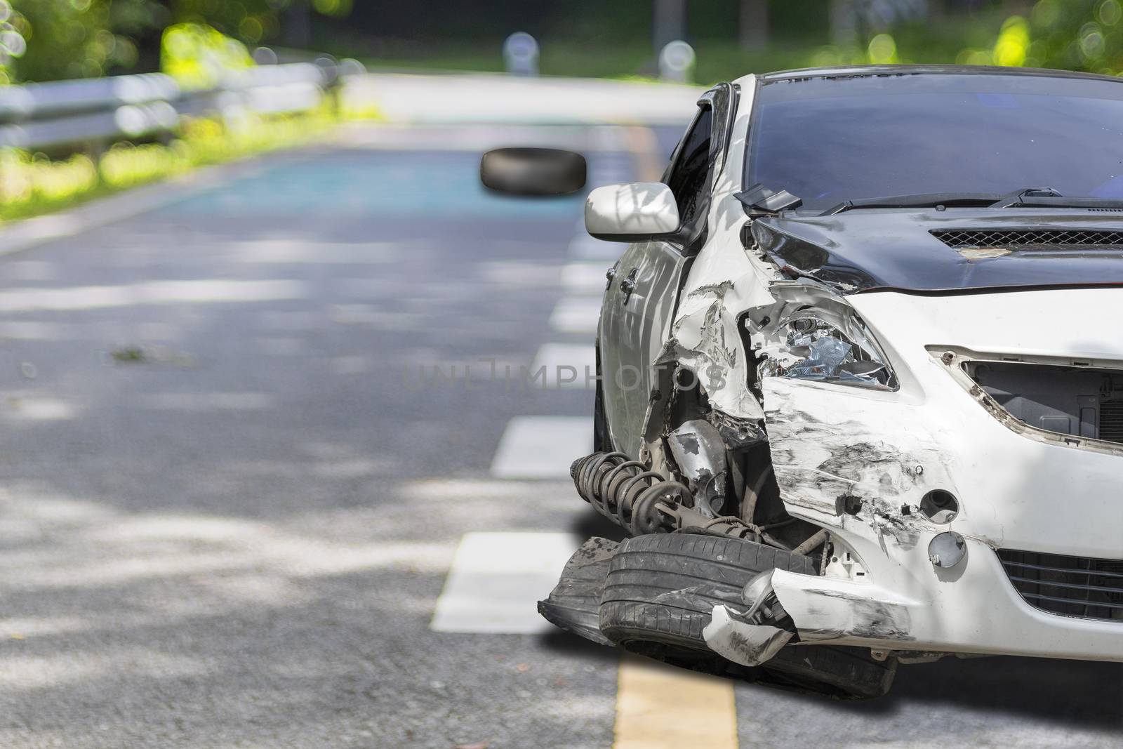 Front of white color car big damaged and broken by accident on city street parking can not drive any more. With copy space for text or design