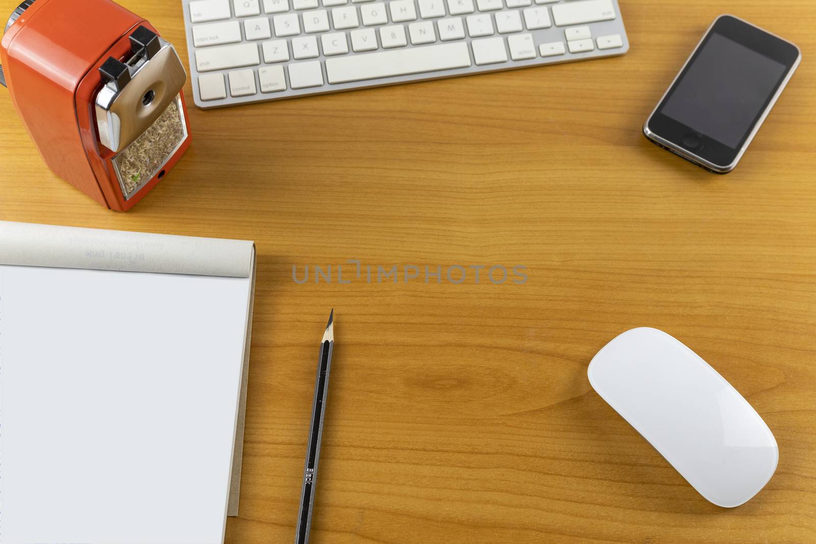 Top view office desk with mouse, laptop, Mobile phone, keyboard, bill book and pencil on wood table . With copy space for text or design.