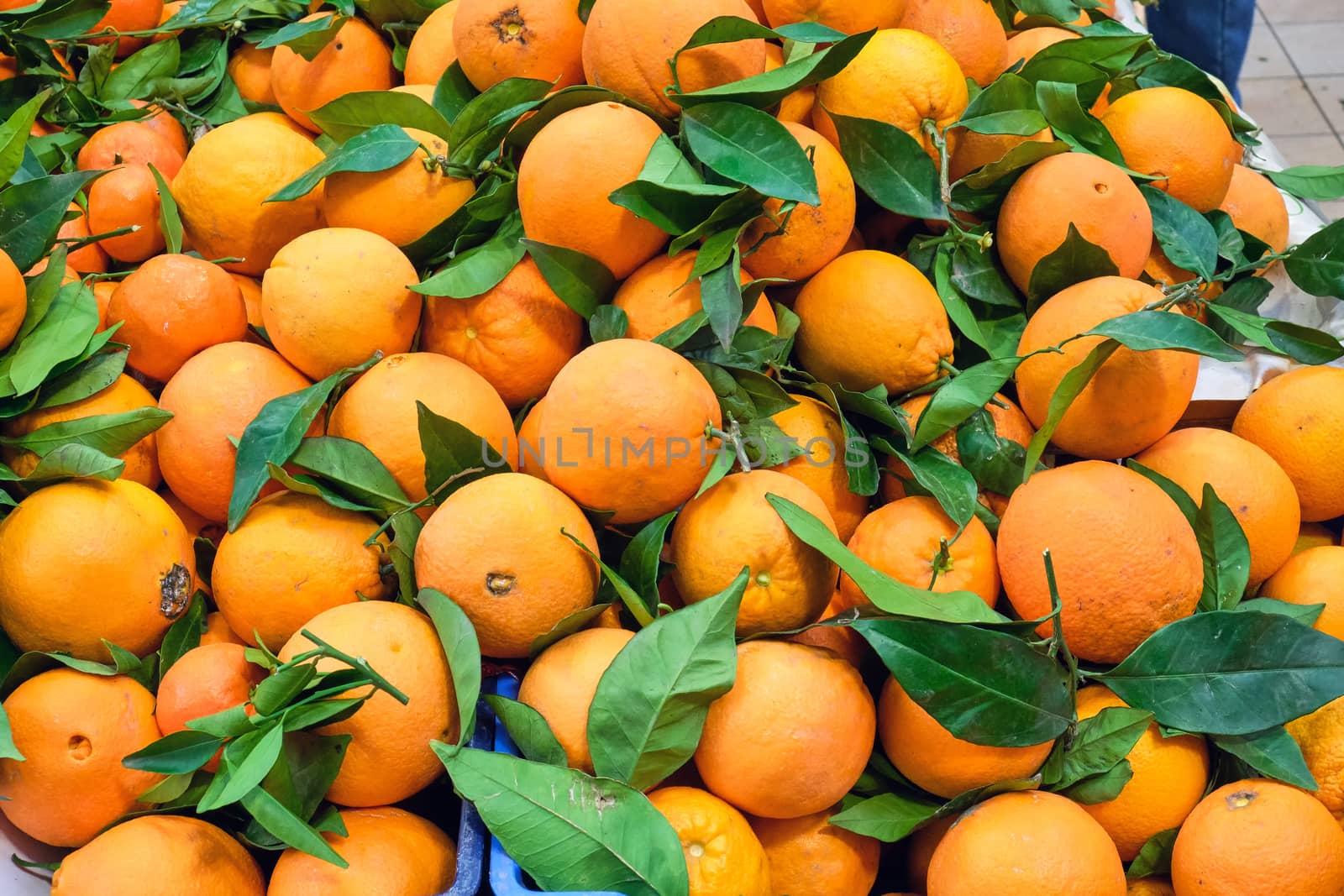 Pile of oranges with leaves by elxeneize