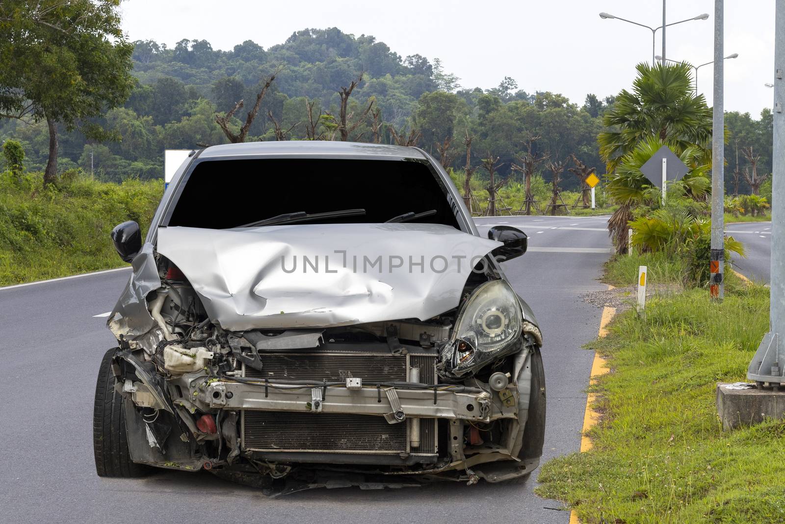 Front of light gray car big damaged and broken by accident on city street parking can not drive any more. With copy space for text or design