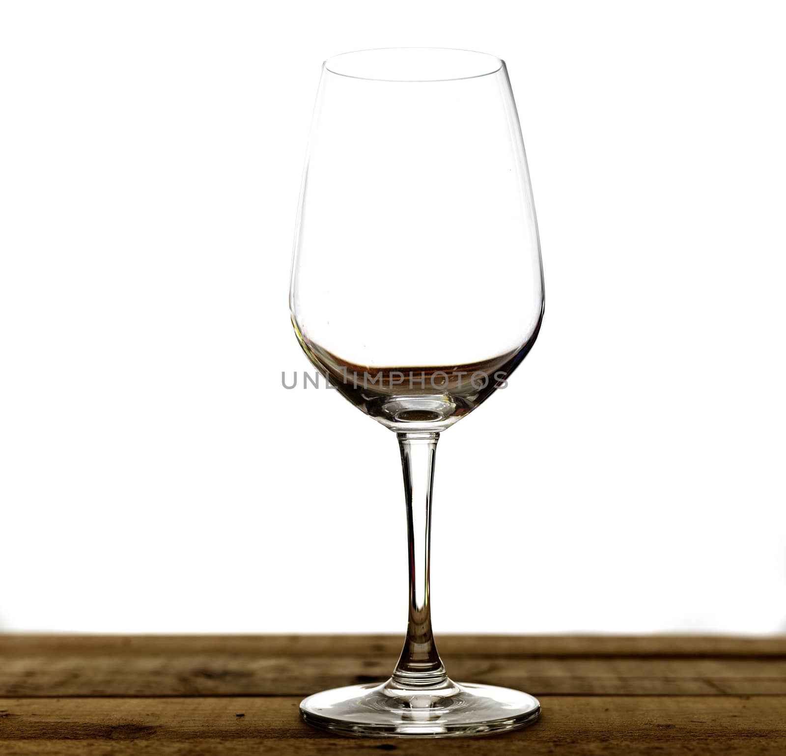 Emty wine glass on wood table. Isolate on white background.