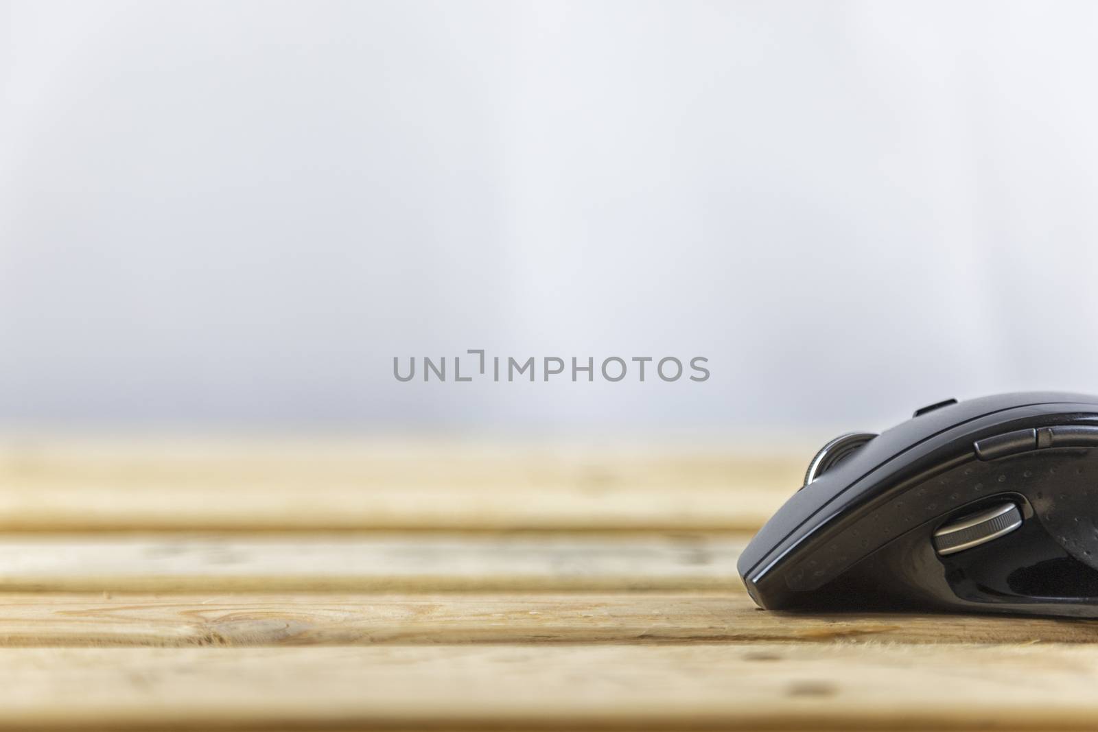 Office concept. Close up head mouse on wood table and white background with copy spce for text or design.