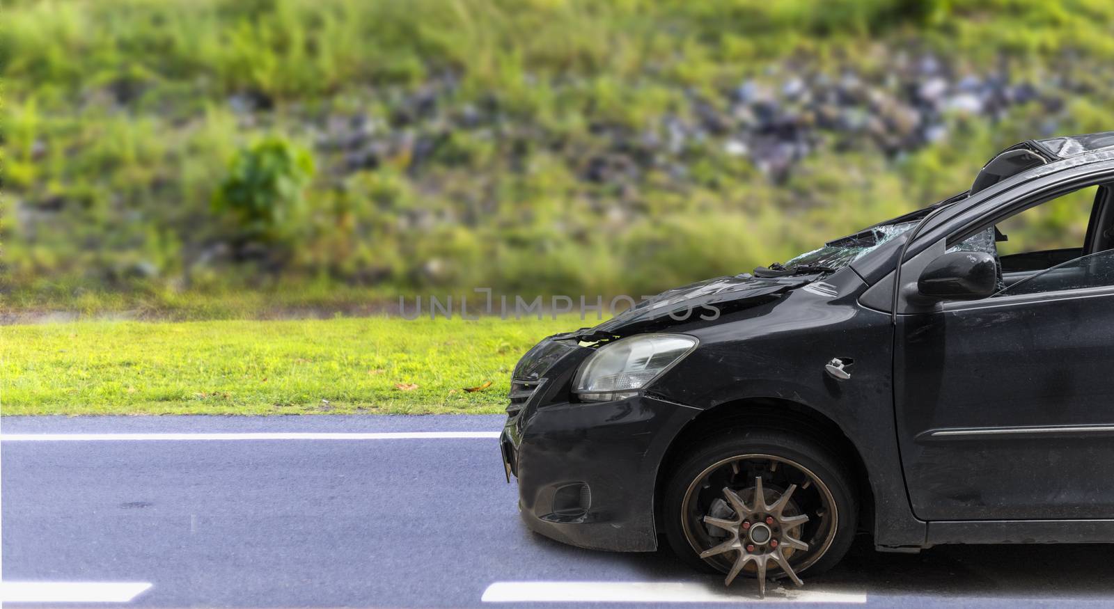 Front of black color car big damaged and broken by accident on city street parking can not drive any more. With copy space for text or designa