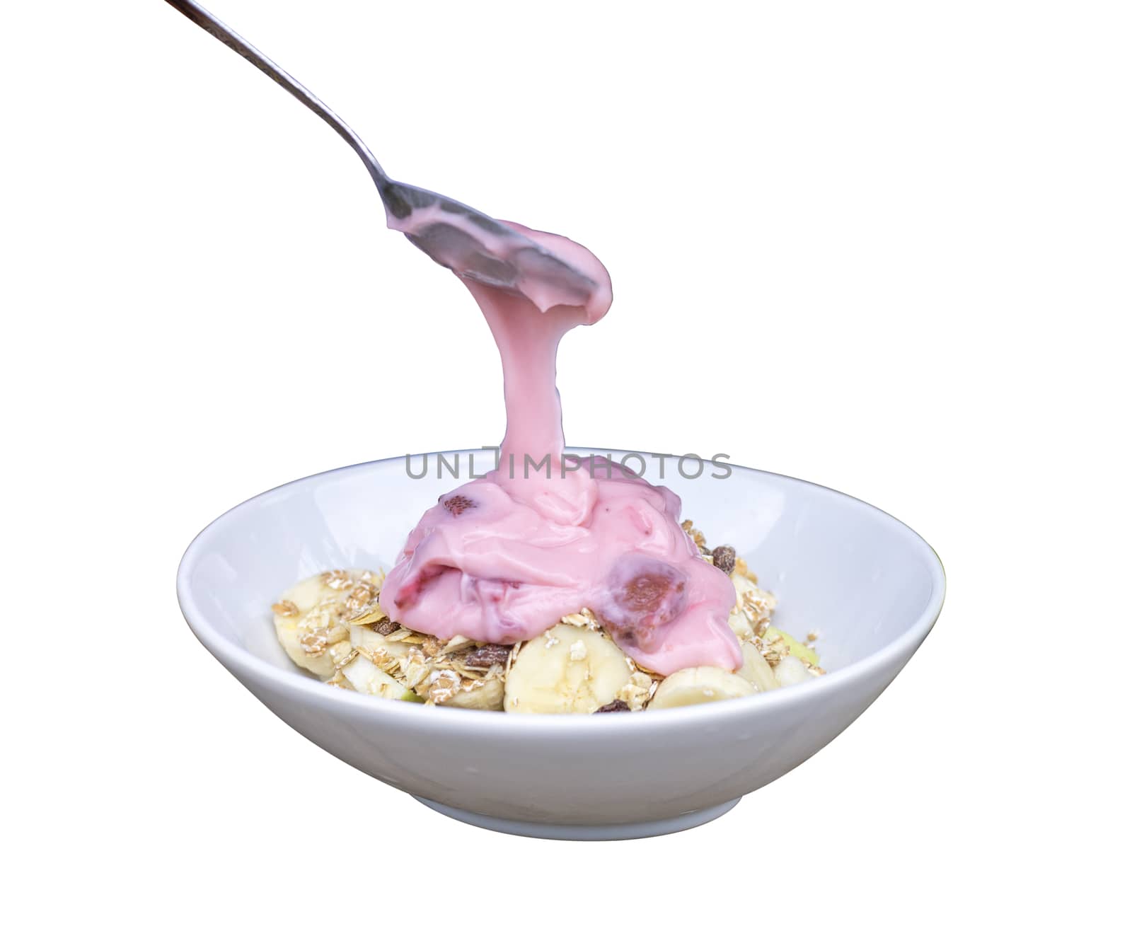 Pour  yogurt strawberry from spoon to bowl and in bowl have banana slide , guava. Isolate on white background. Save with cliping path.
