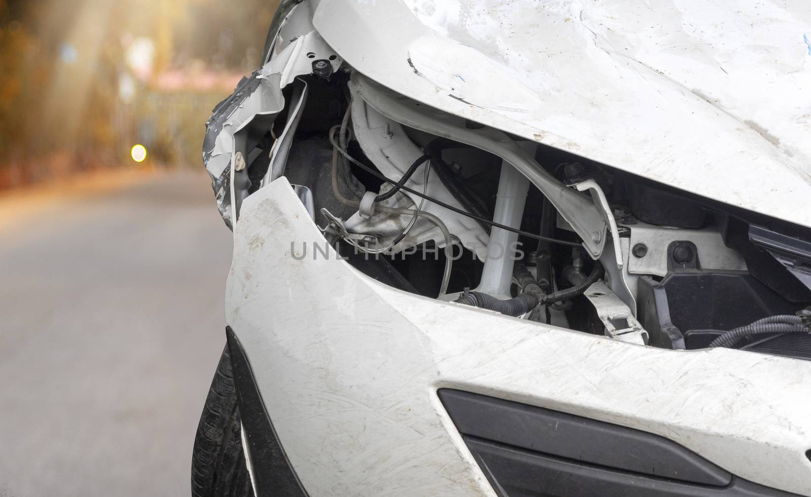 Close up head light of  white color car have damaged and broken by accident on road parking can not dirve any more. 