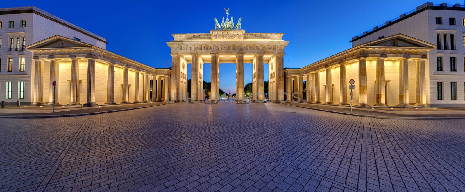 Panorama of the illuminated Brandenburg Gate in Berlin after sunset with no people