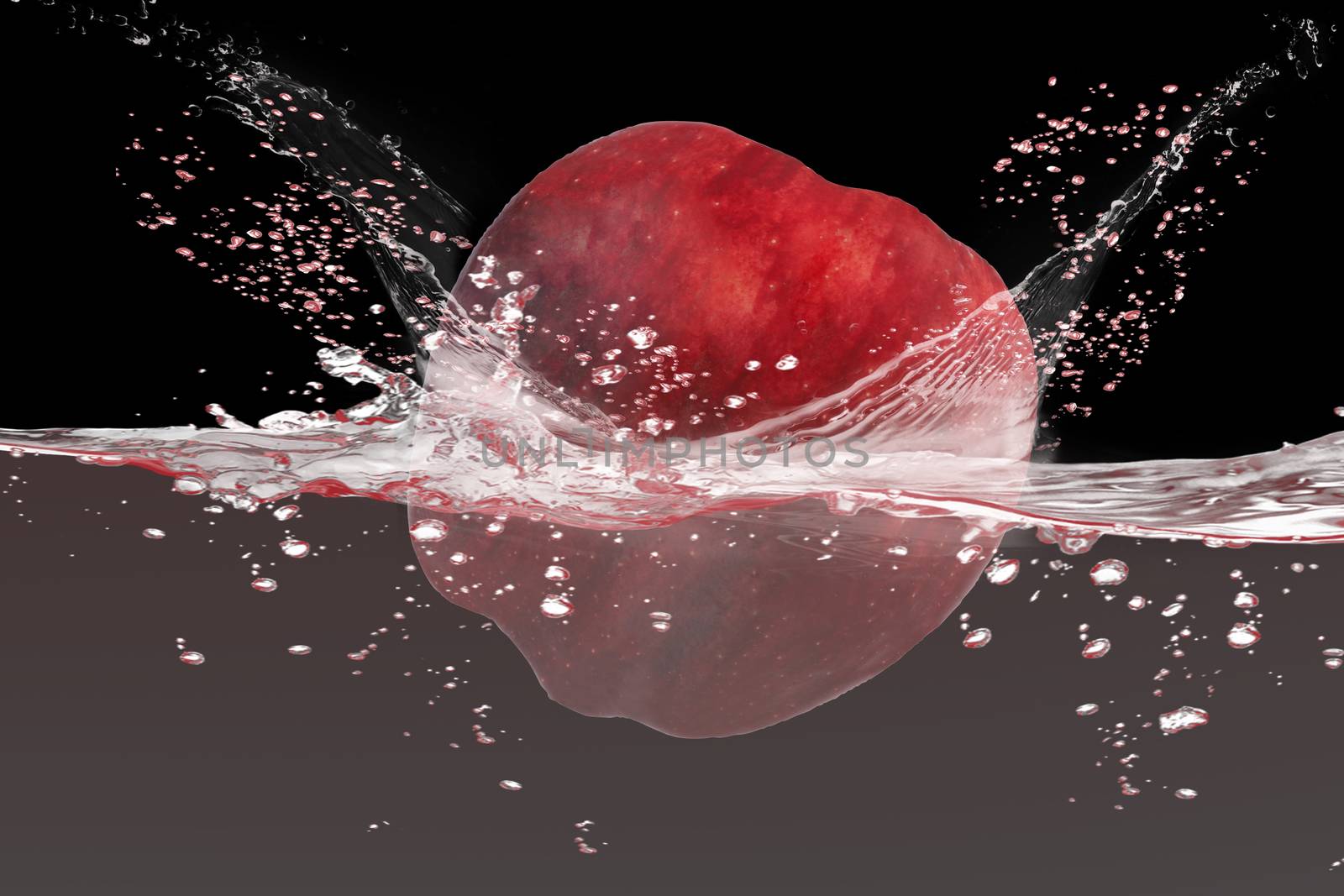 Red apple falling in to water with splash isolate on black background.