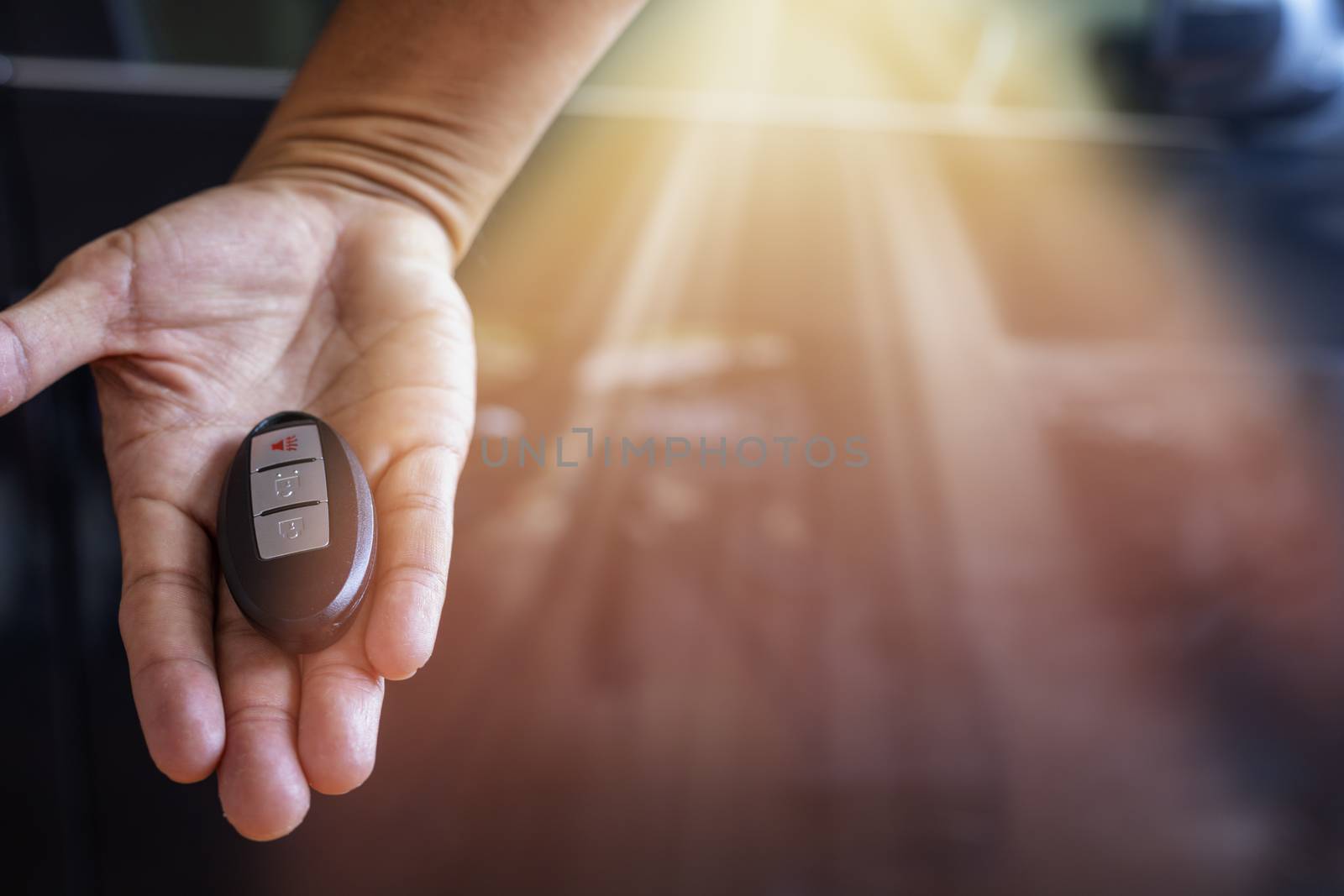 Car key remote on hand. Hand man giving a car remote. 