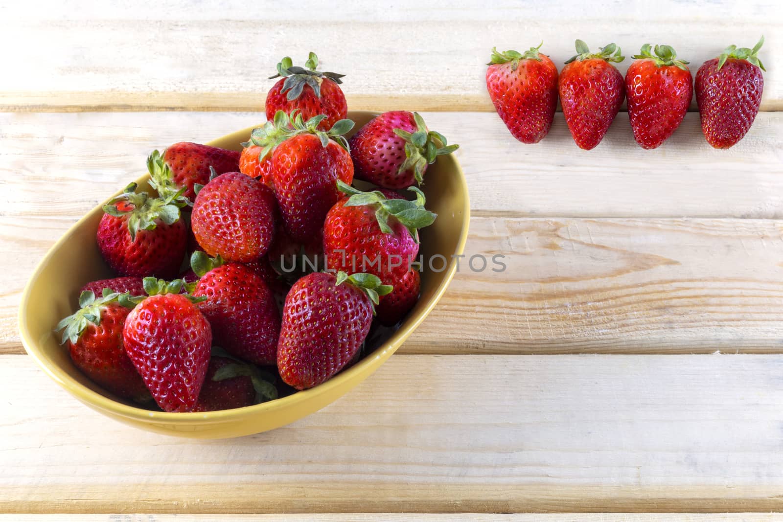 strawberrys in blow on the wood table with copy space for text or design.