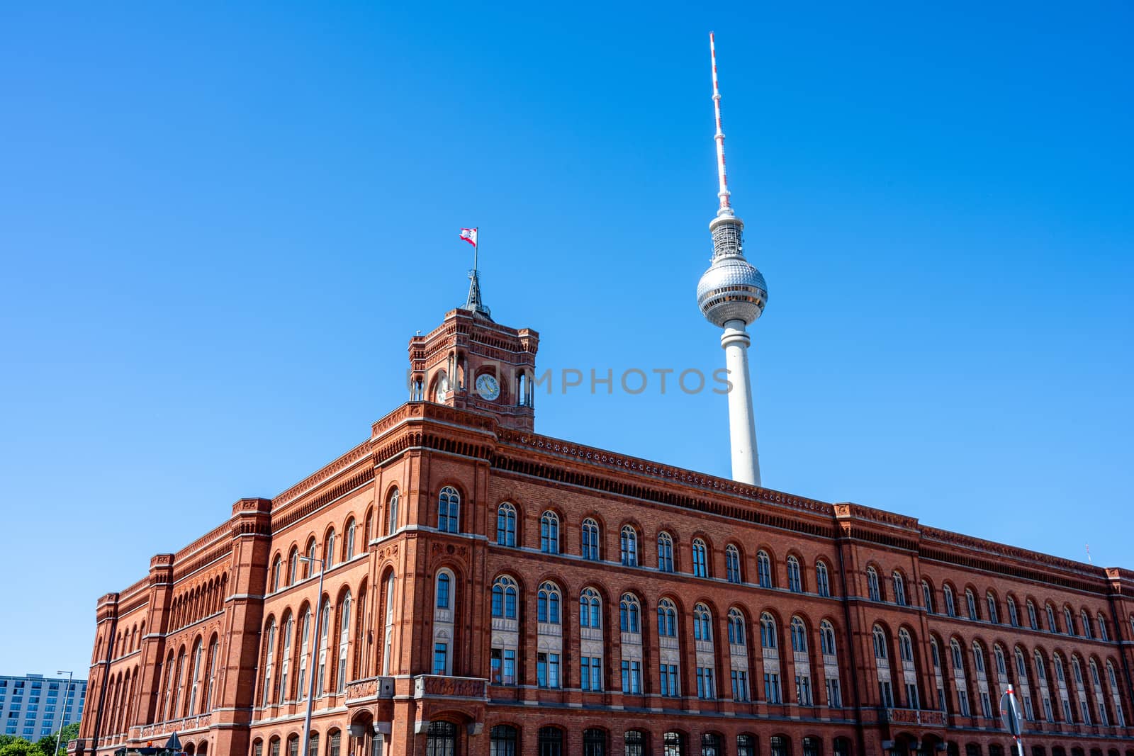 The famous Television Tower and the city hall in Berlin in front of a clear blue sky