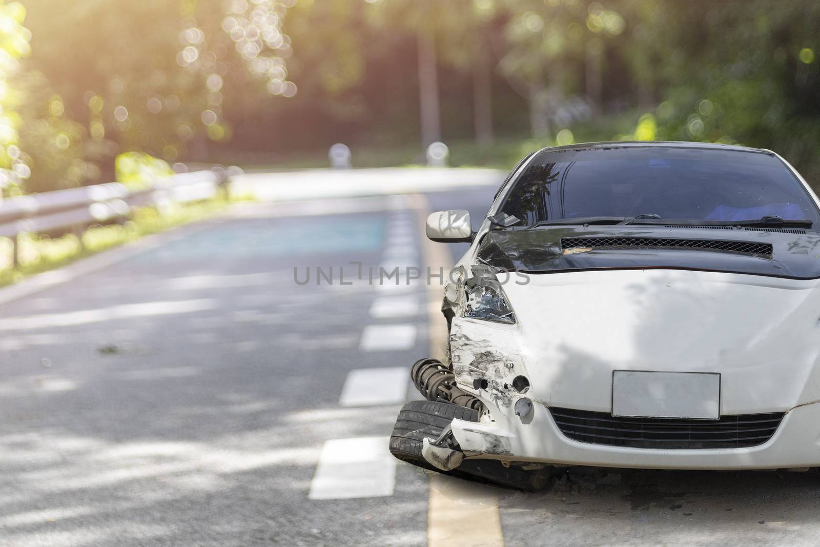 Front of white color car big damaged and broken by accident on city street parking can not drive any more. With copy space for text or design
