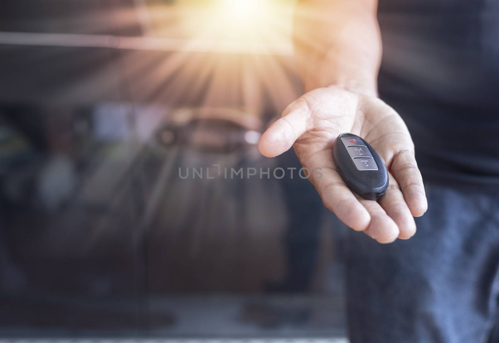 Car key remote on hand. Hand man giving a car remote. 