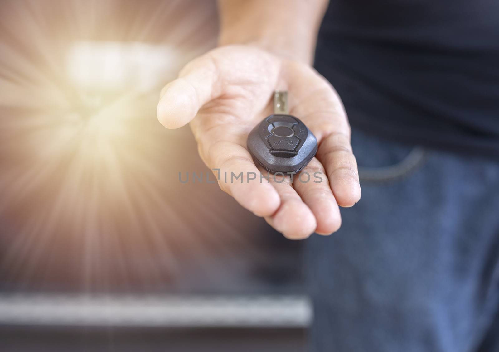 Car key remote on hand. Hand man giving a car key. 