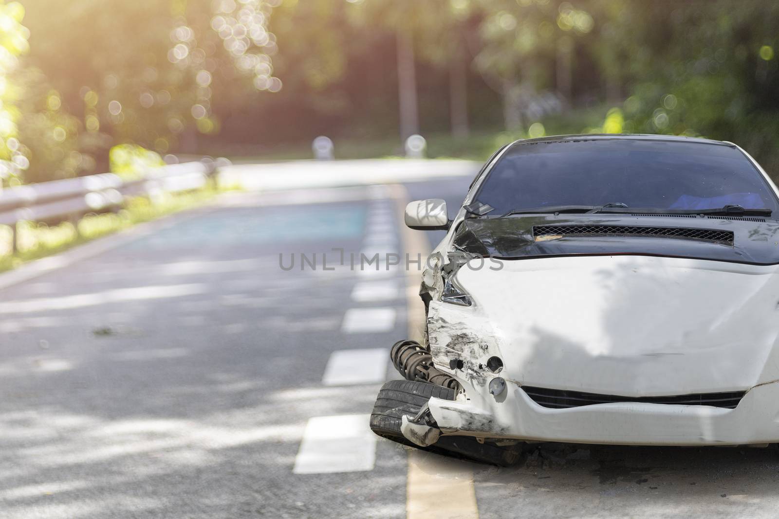 Front of white color car big damaged and broken by accident on city street parking can not drive any more. With copy space for text or design